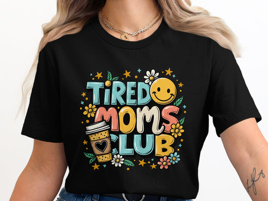 Tired Moms Club text with smiley face, coffee cup, and flowers.