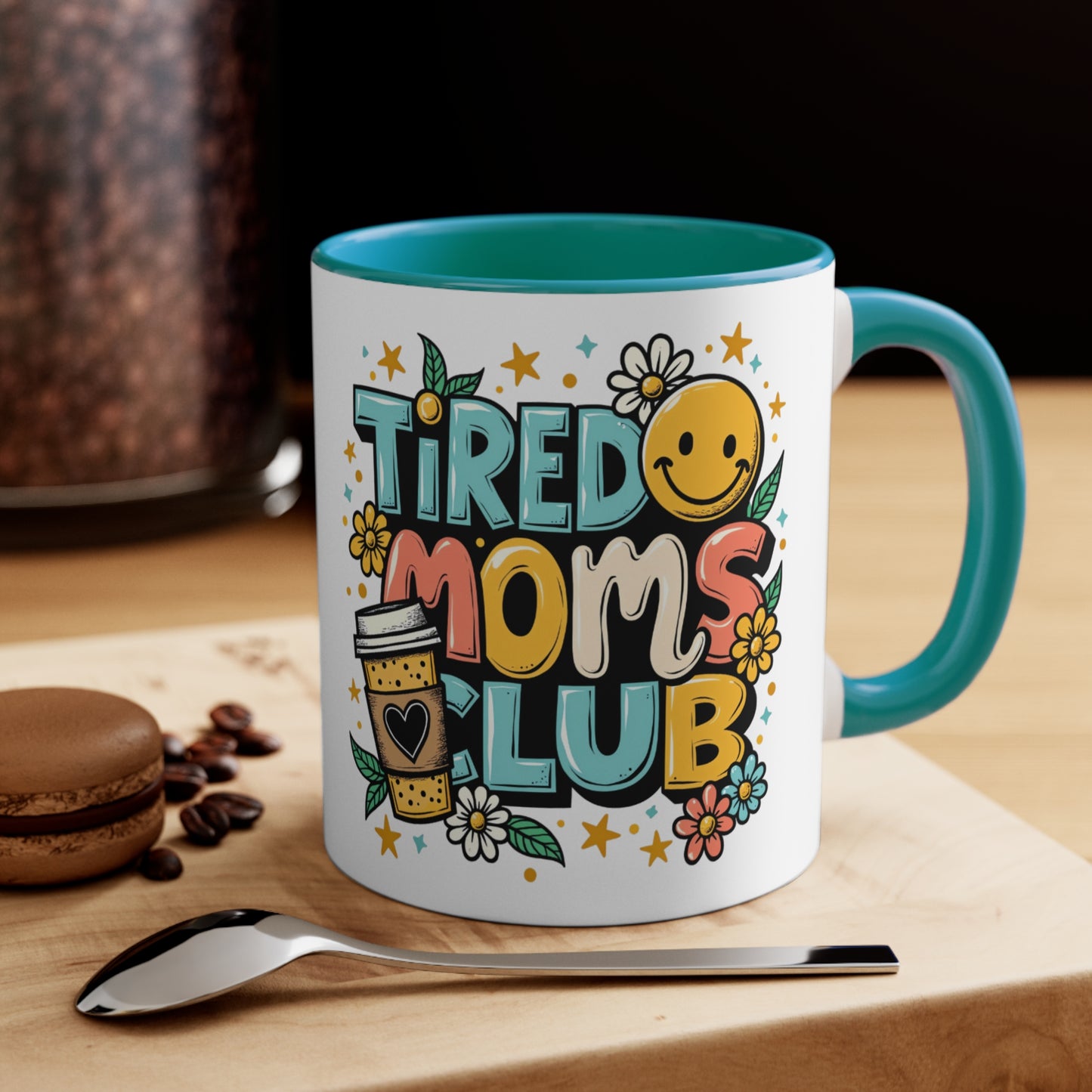 Mug with "Tired Moms Club" text, a smiley face, and flowers.