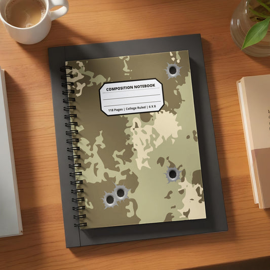 Camouflage composition notebook with bullet hole design.