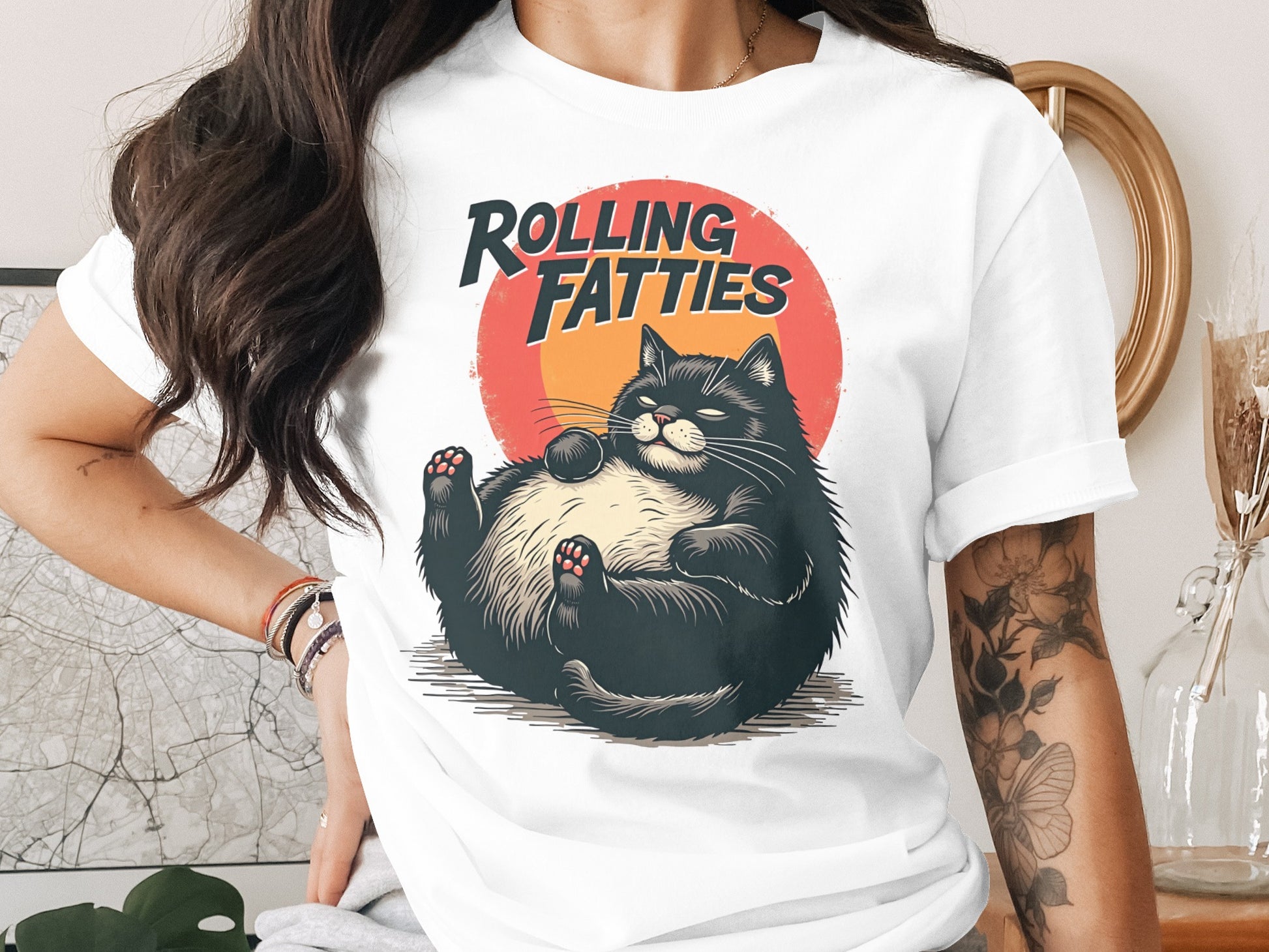 Black cat lounging on back with "Rolling Fatties" text above.