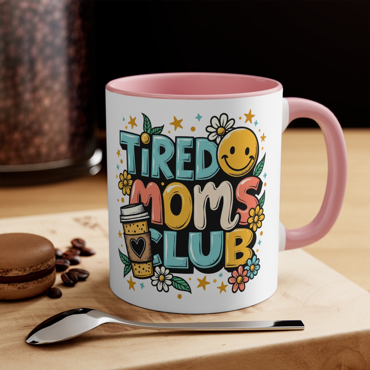 Mug with "Tired Moms Club" text, coffee cup icon, and floral designs.