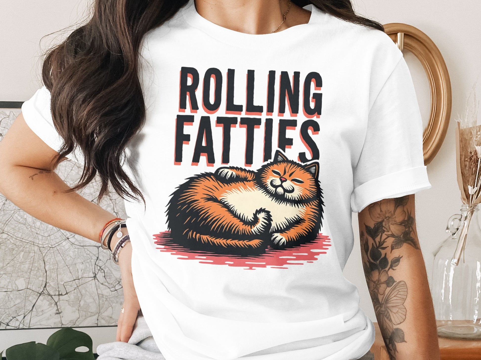 T-shirt with illustration of a ginger cat named "Rolling Fatties" lying down.